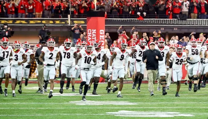 georgia bulldogs team running into the field