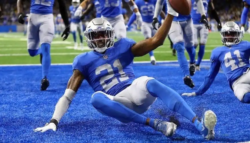 Detroit Lions player celebrates in the end zone after a touchdown.