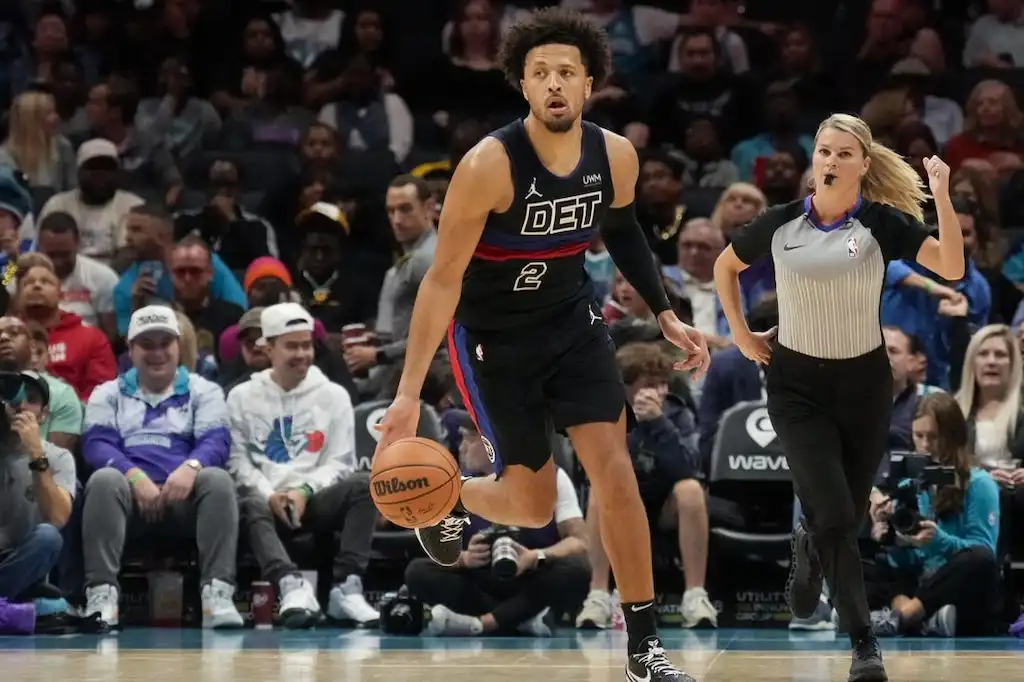 Detroit Pistons player number 2 dribbles the basketball up the court during an NBA game.
