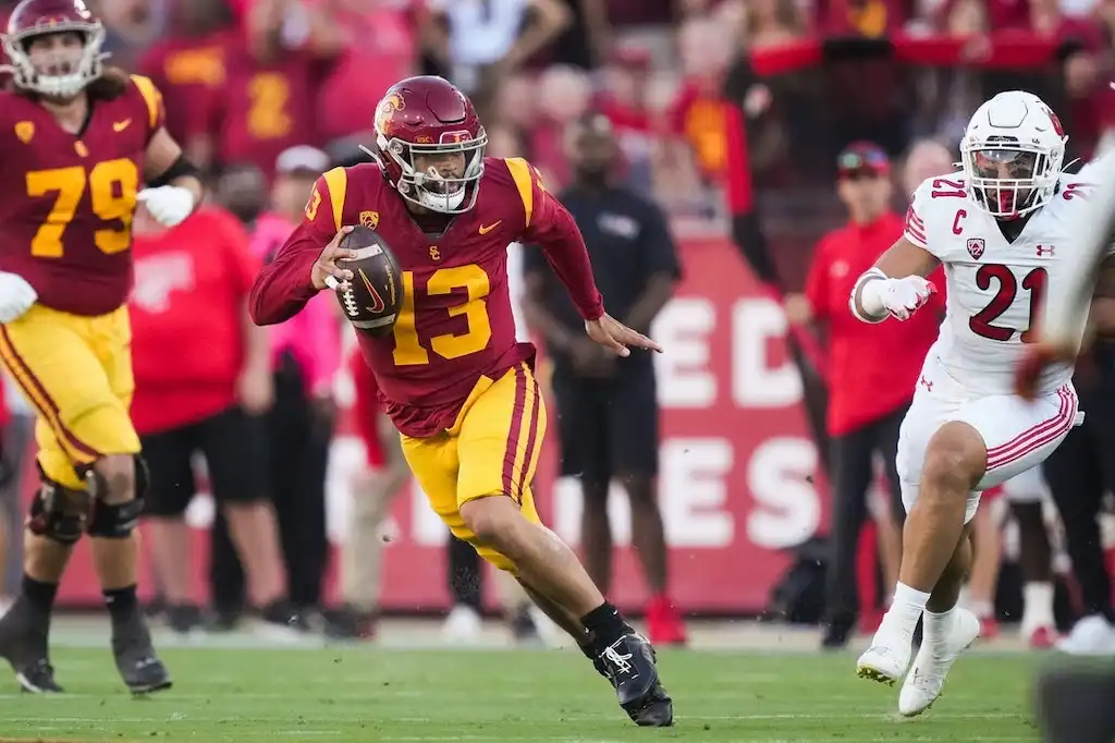 USC quarterback runs with the football during a game against Utah.