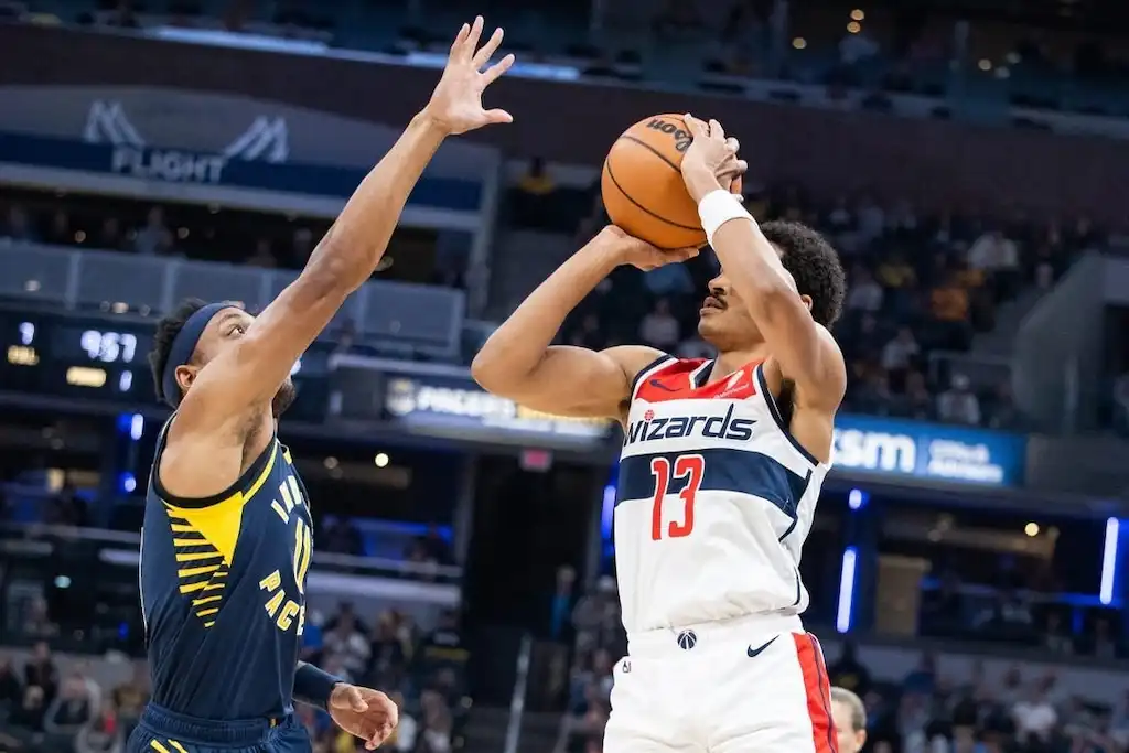 A Washington Wizards player rises for a jump shot.