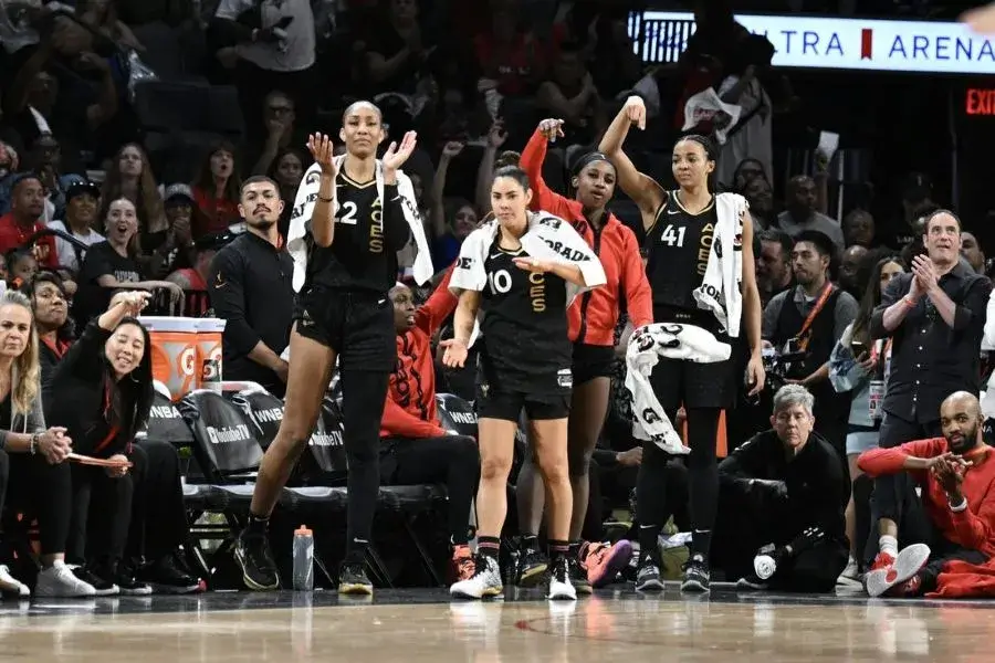 las vegas aces wnba players standing courtside 1