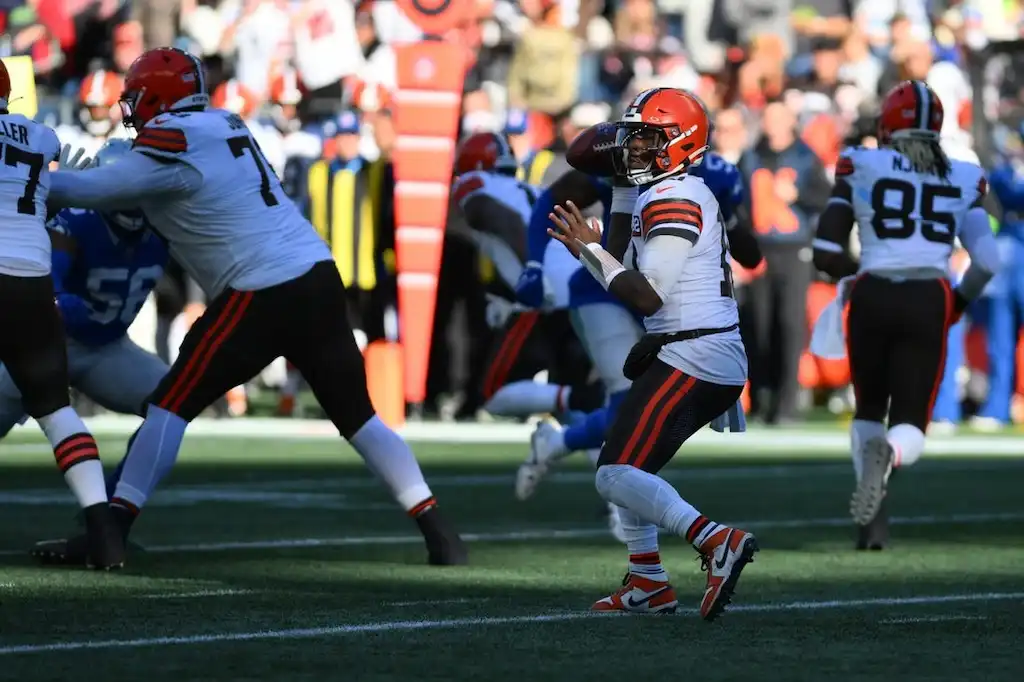 Cleveland Browns quarterback winds up to throw a pass during an NFL game.