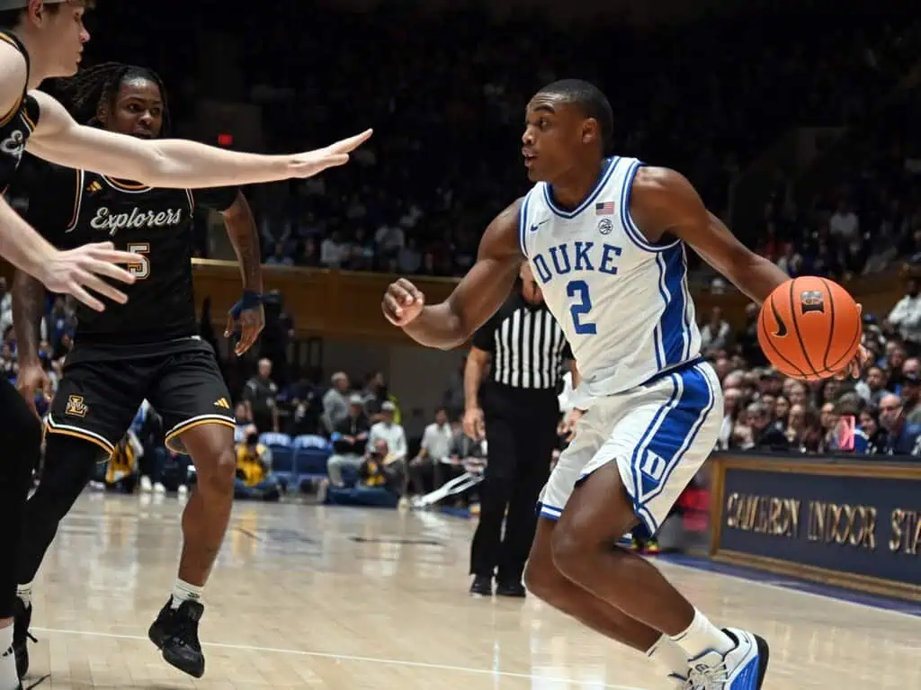 Duke Blue Devils player # 2 dribbles the ball while driving toward the basket against La Salle Explorers defenders.