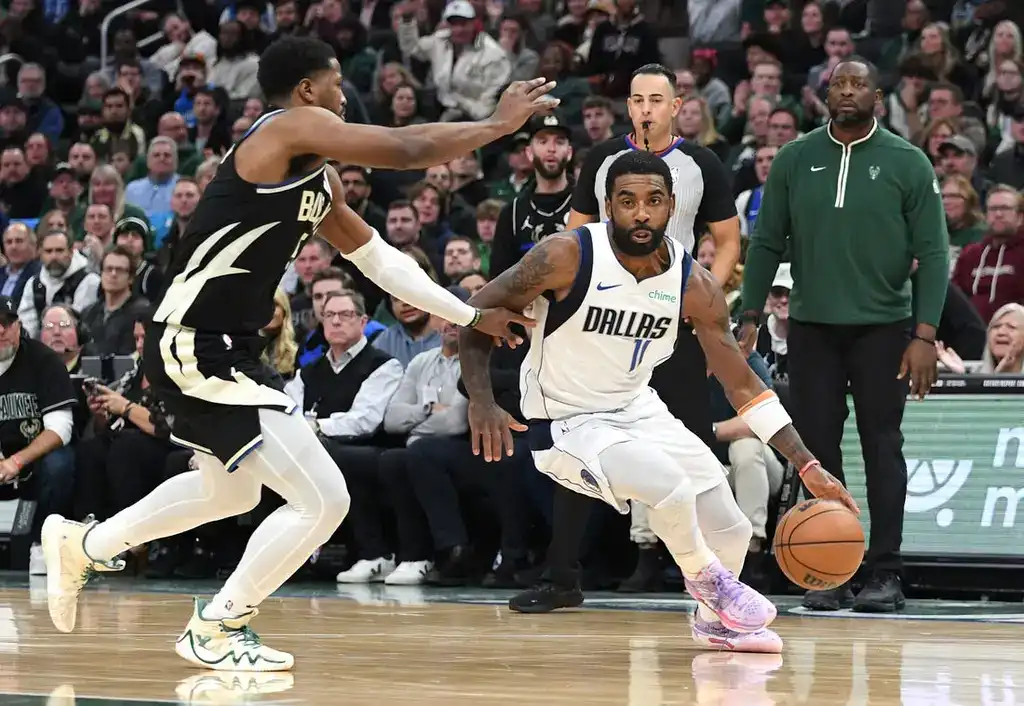 7 Kyrie Irving of the Dallas Mavericks drives past a defender during an NBA game