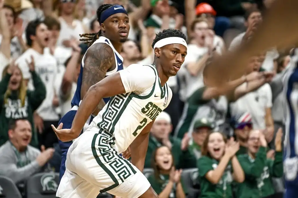 A Michigan State basketball player celebrates after a big play.