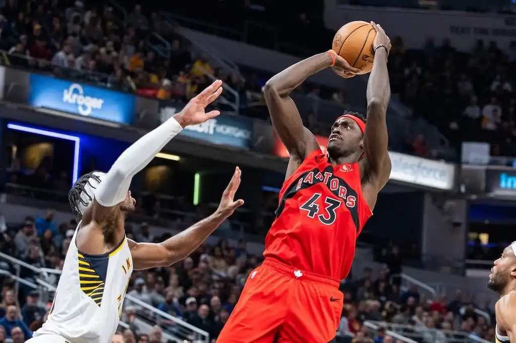 6 Toronto Raptors player, number 43, jumps to take a shot during a basketball game.