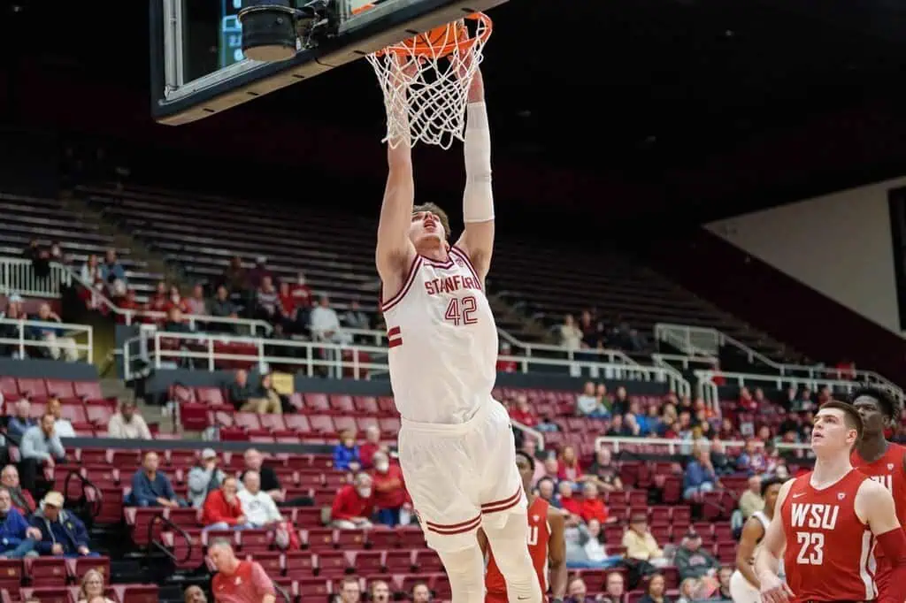 Stanford player number 42 goes up for a dunk during a college basketball game against the Washington State.