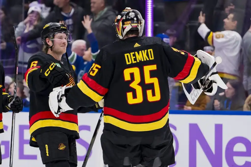 Vancouver Canucks goalie Thatcher Demko, celebrates with a teammate after a game.