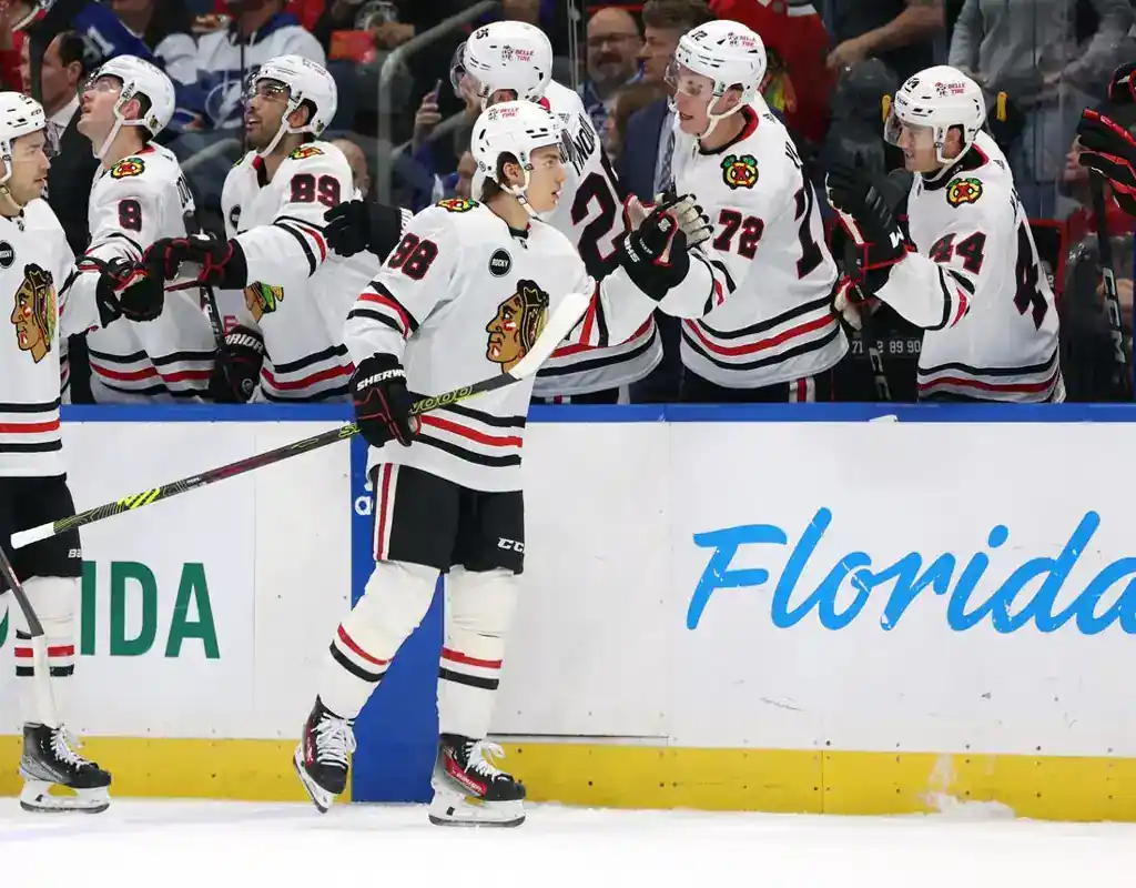 Chicago Blackhawks players celebrate at the bench during their November 16, 2023 game against the Tampa Bay Lightning