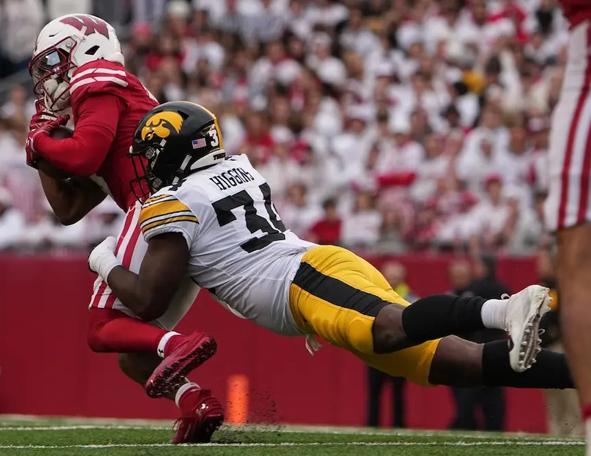 iowa hawkeyes player tackling rival player