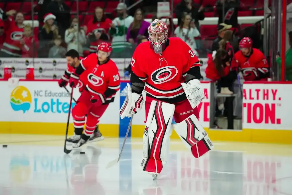 Carolina Hurricanes goalie leads teammates onto the ice during warmups.