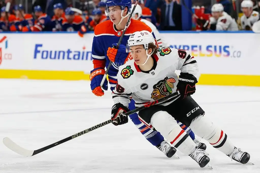 Chicago Blackhawks player skates with the puck during an NHL game against the Edmonton Oilers.
