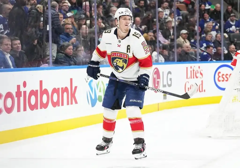Florida Panthers player stands on the ice near the boards.