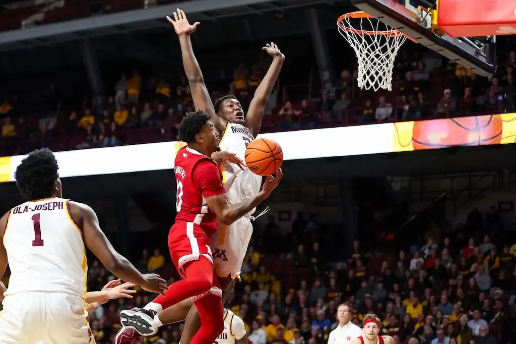 A Nebraska player drives to the basket for a layup.