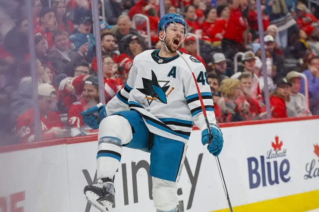 San Jose Sharks player celebrates after scoring a goal during an NHL game.