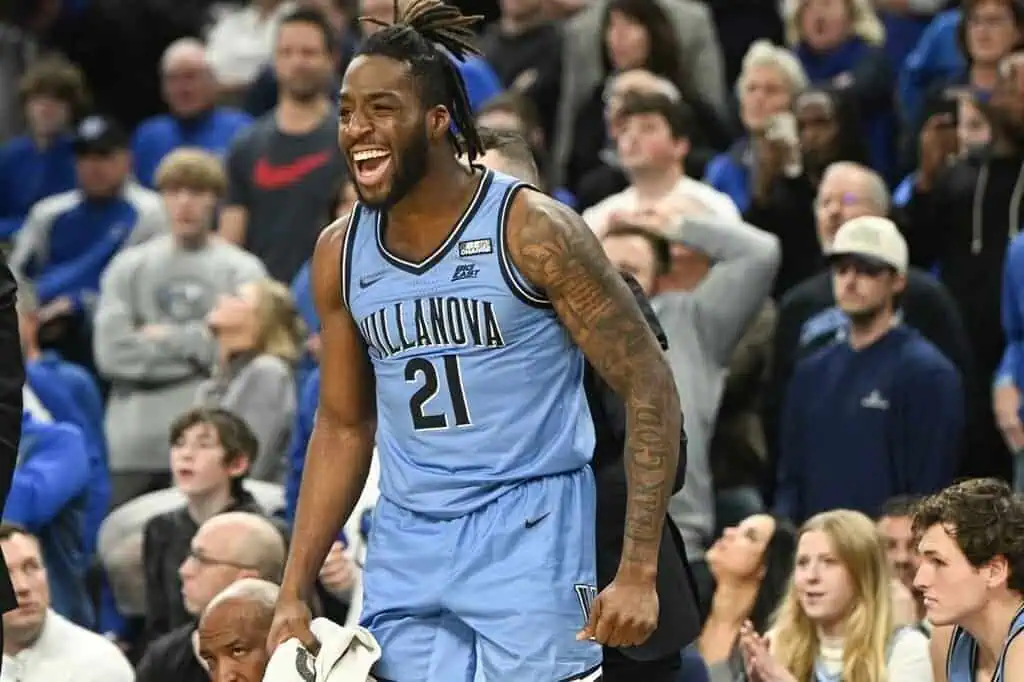 Villanova player, wearing jersey #21, caught in a moment of pure joy—possibly after a big play or a crucial win.