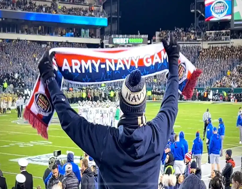 NCAAF 9 A Navy fan holds up an “Army-Navy Game” scarf at a packed football stadium during the annual rivalry game on December 9, 2023.