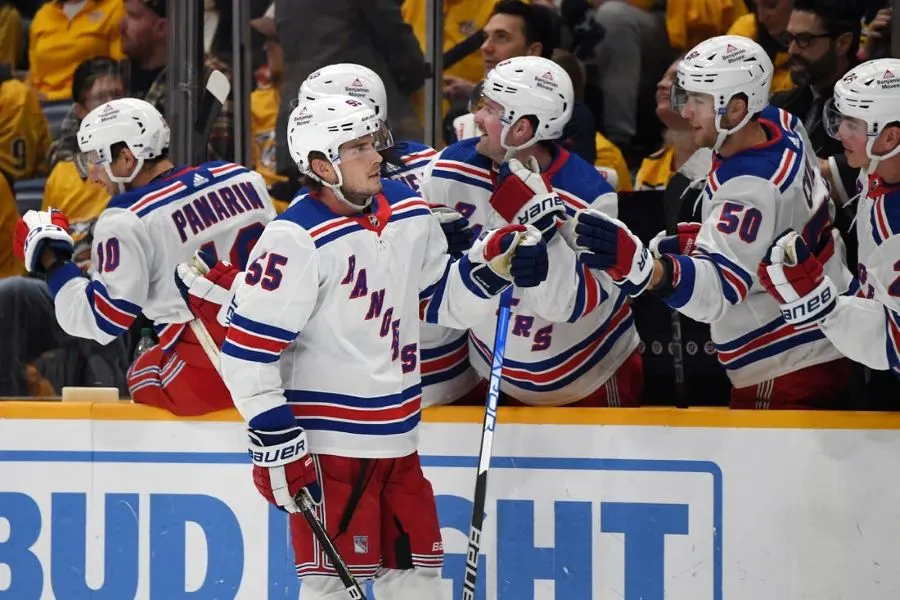 new york rangers players watching a play