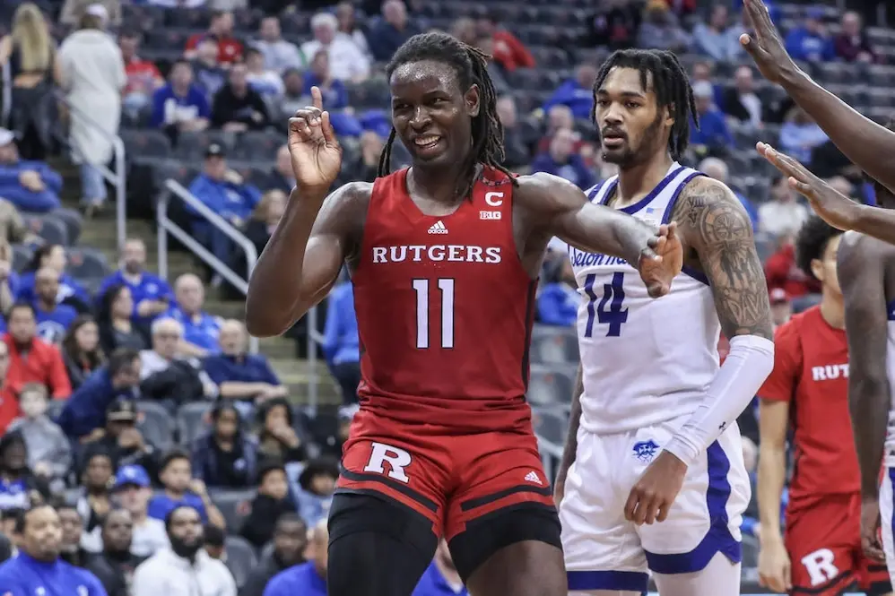 rutgers ncaab player pointing up