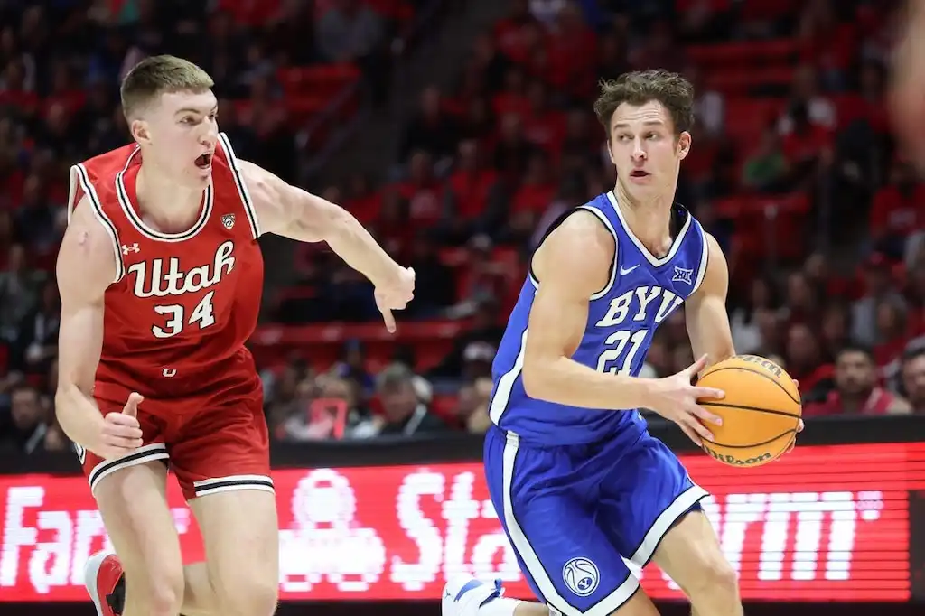 A BYU basketball player drives toward the basket.