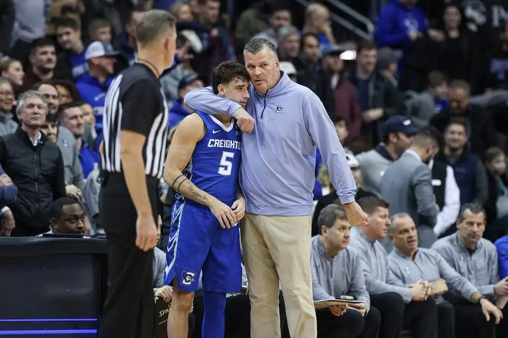 Creighton coach giving instructions during a college basketball game.