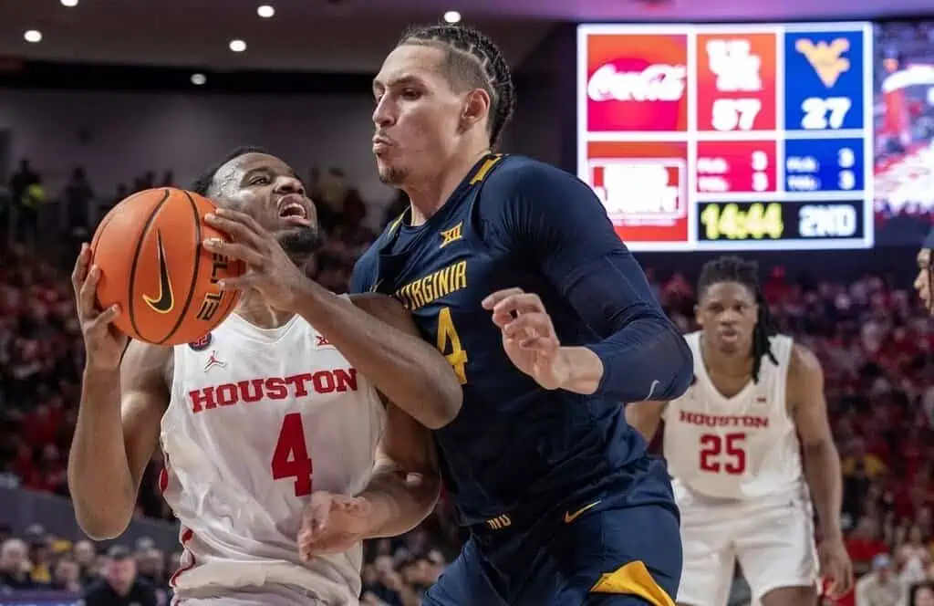 Intense moment during a college basketball game between the Houston Cougars and the West Virginia Mountaineers.