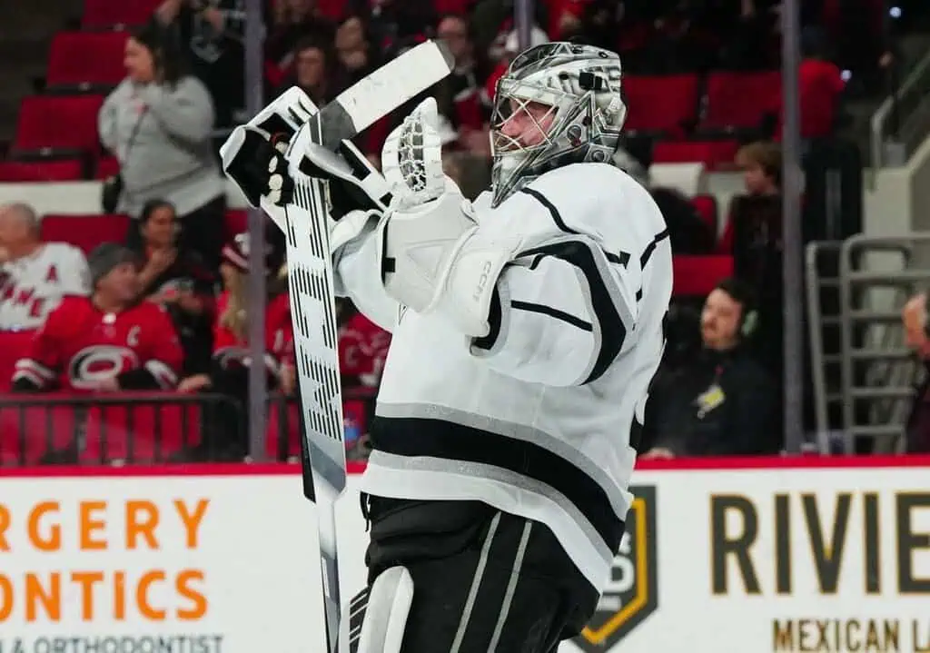 NHL goalie from the Los Angeles Kings, captured mid-game in a moment of reaction after making a save.