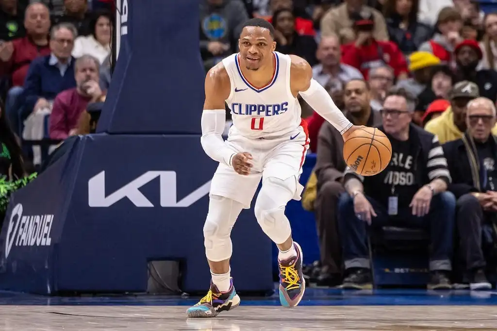 8 A Clippers basketball player dribbles up the court with focus during an NBA game.