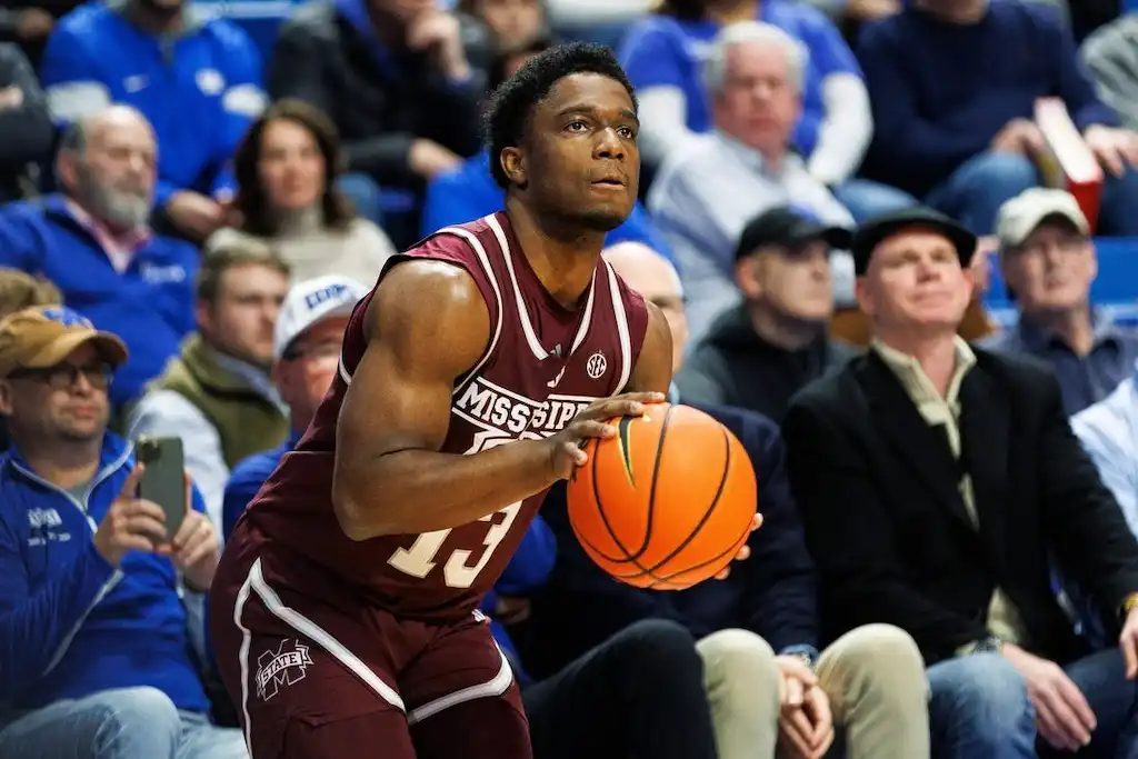 A Mississippi State basketball player prepares to shoot the ball.
