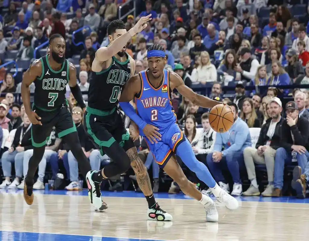 4 Oklahoma City Thunder guard drives past Boston Celtics defenders during fast-paced NBA game