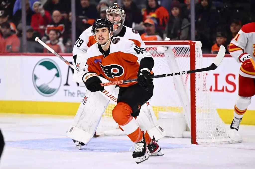 Philadelphia Flyers player skates in front of the goal during an NHL game.