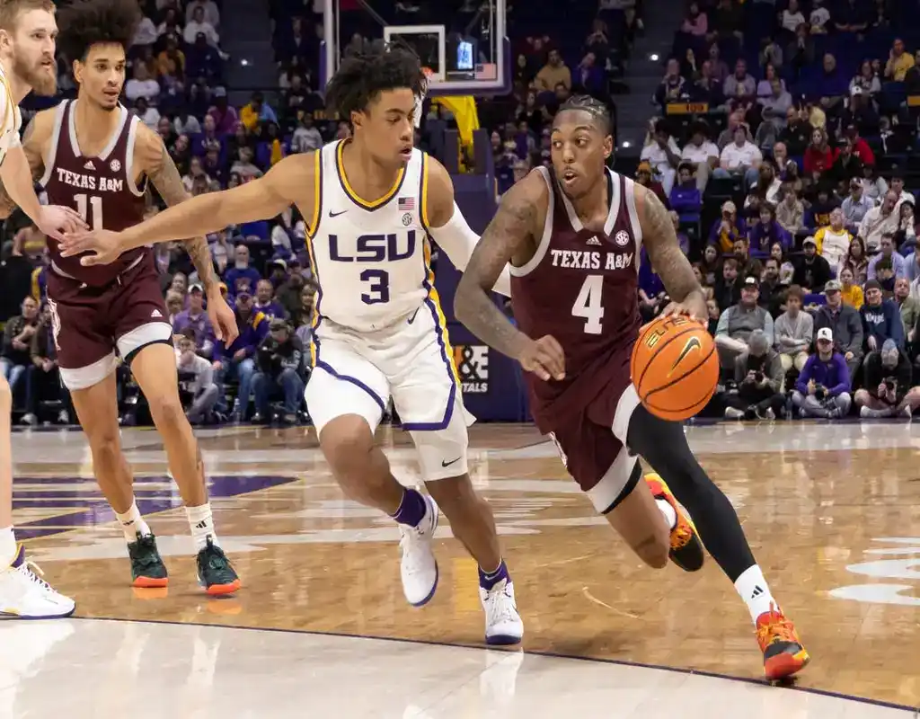 NCAAB 4 Texas A&M player drives past LSU defender during a college basketball game