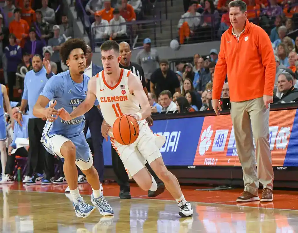 Clemson Tigers player drives the ball past a North Carolina defender during a game ahead of their January 10, 2024 matchup with Virginia Tech