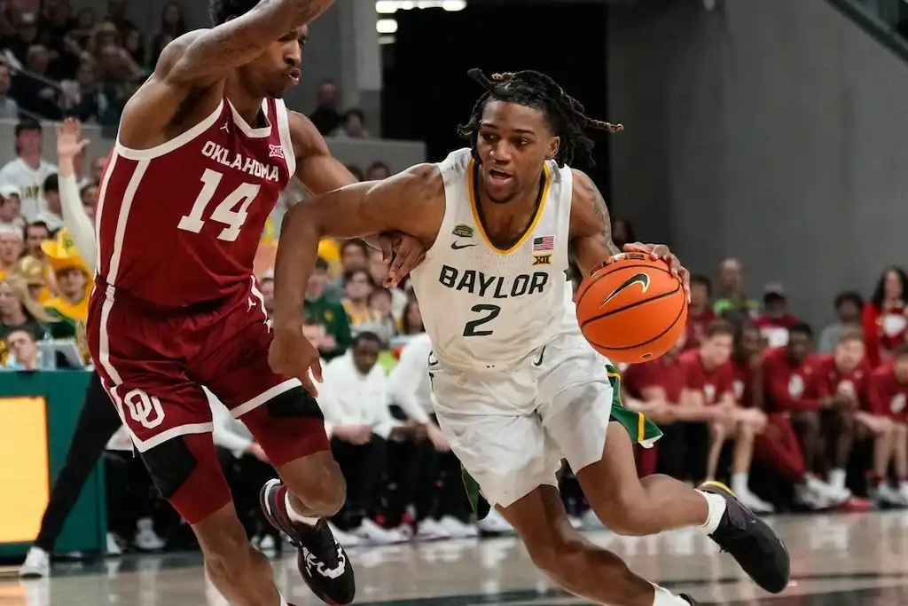 Baylor basketball player drives aggressively toward the basket.