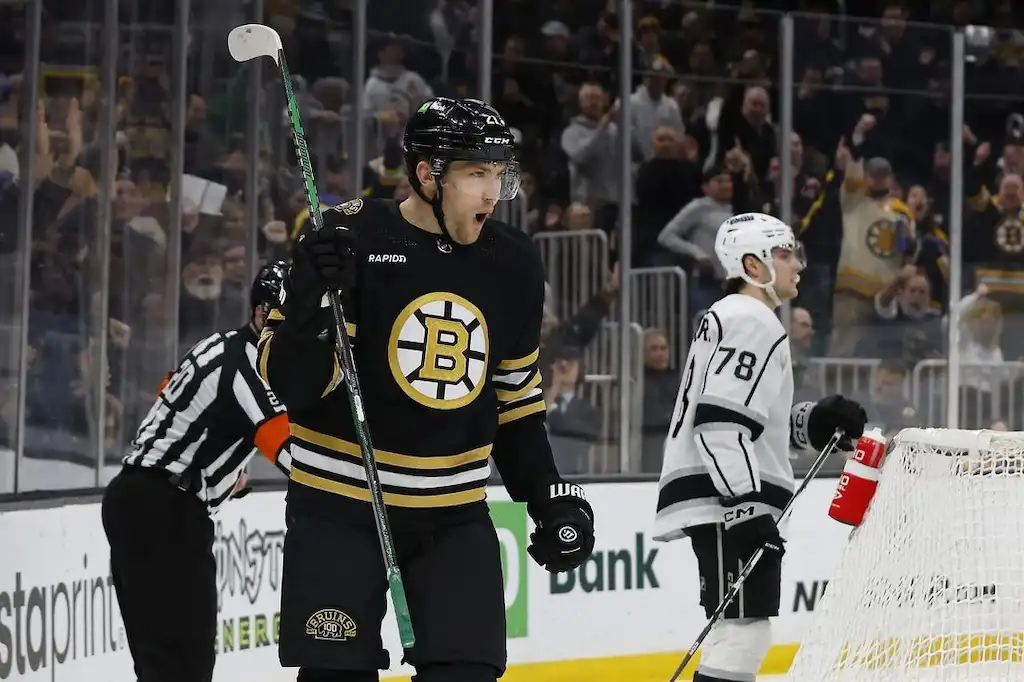NHL 4 A Boston Bruins player celebrates with a loud yell after scoring a goal.