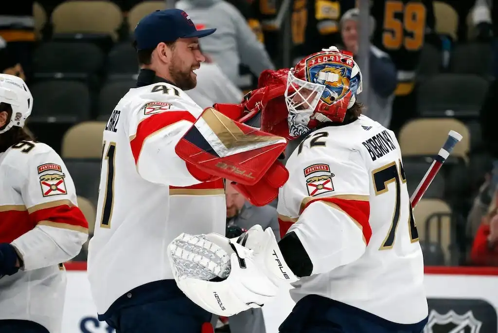 NHL 9 Two Florida Panthers players celebrate on the ice after a victory.