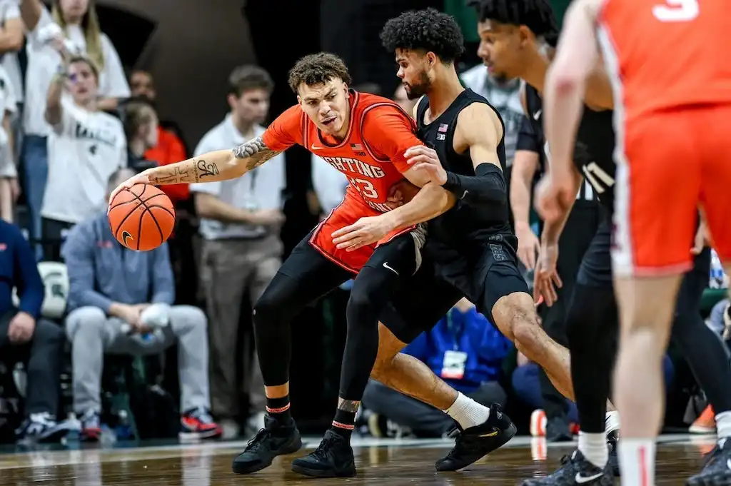 Illinois player attempts to drive past a defender in during a tightly contested game.