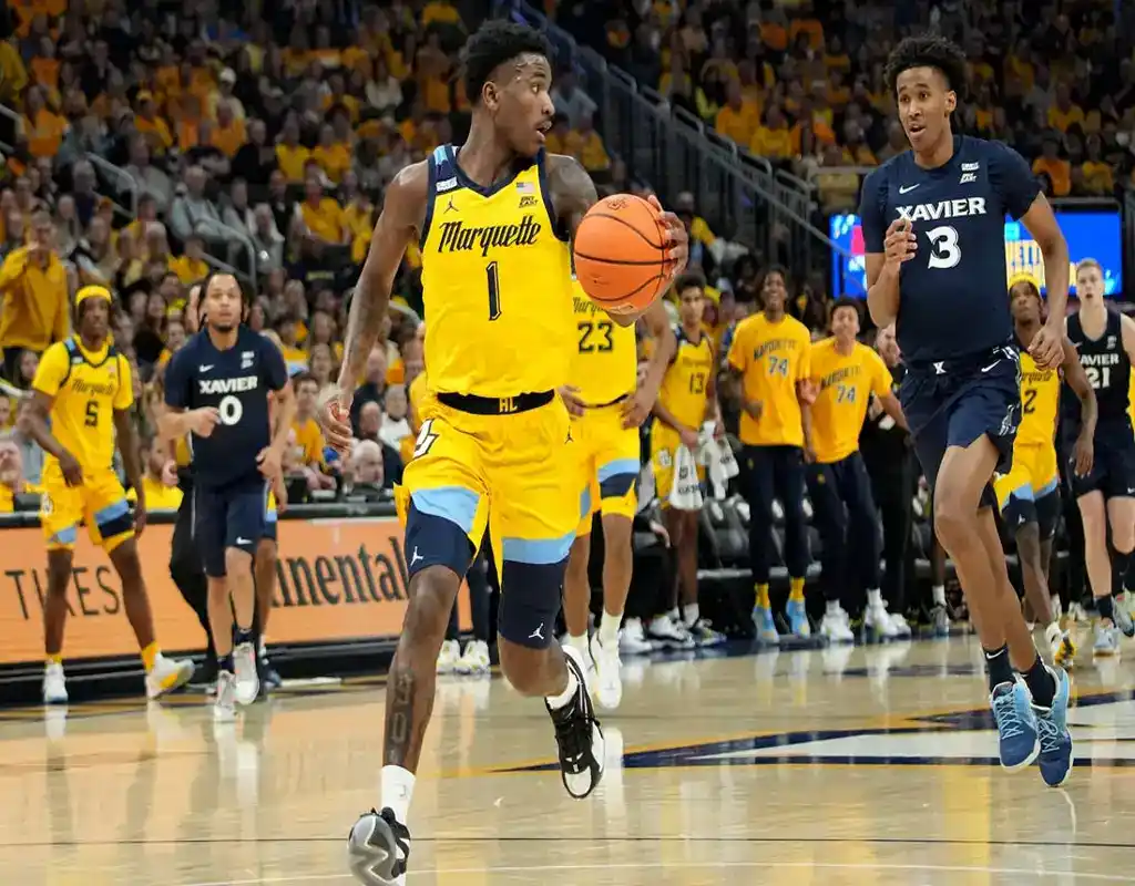 NCAAB 5 Marquette Golden Eagles player leads fast break while being chased by Xavier defenders during college basketball game