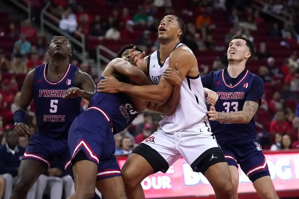 Players from San Diego State and another team fight for rebounding position under the basket.