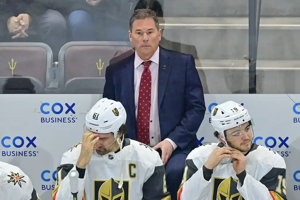 NHL 7 Vegas Golden Knights coach stands behind the bench with players.