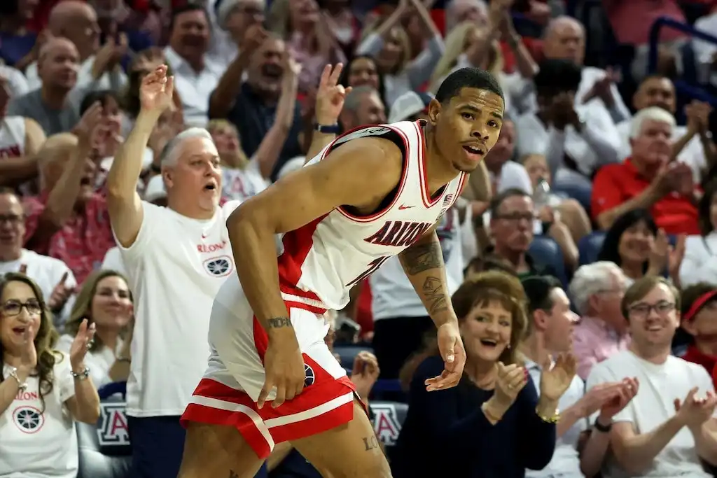 NCAAB 2 Arizona Wildcats basketball player celebrates on the court.