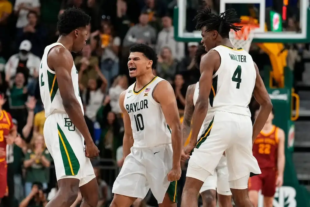 Baylor basketball players celebrate on the court.
