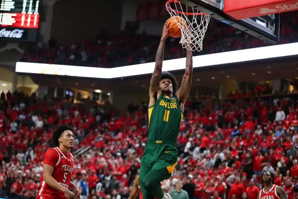 Baylor Bears player number 11 dunks the ball during a college basketball game against Texas Tech.