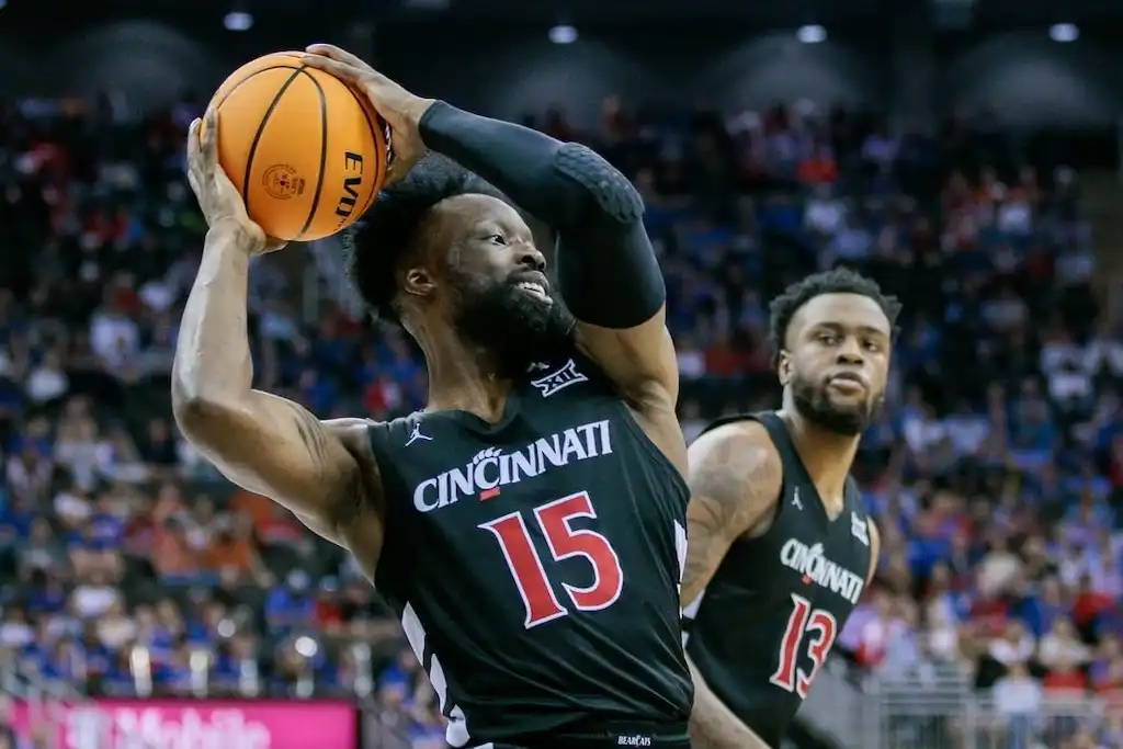 A Cincinnati Bearcats basketball player prepares to make a pass.