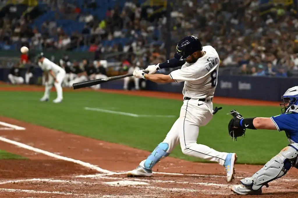 8 Tampa Bay Rays batter Brandon Lowe makes contact with the ball during a game.