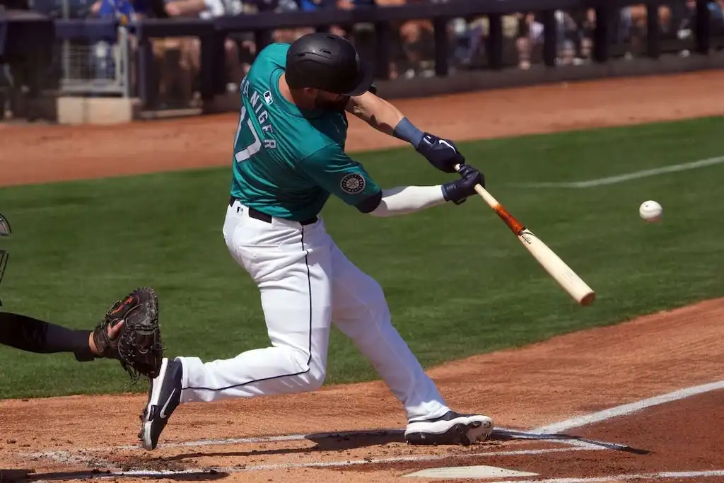 Seattle Mariners batter Mitch Haniger swings at a pitch during a game.