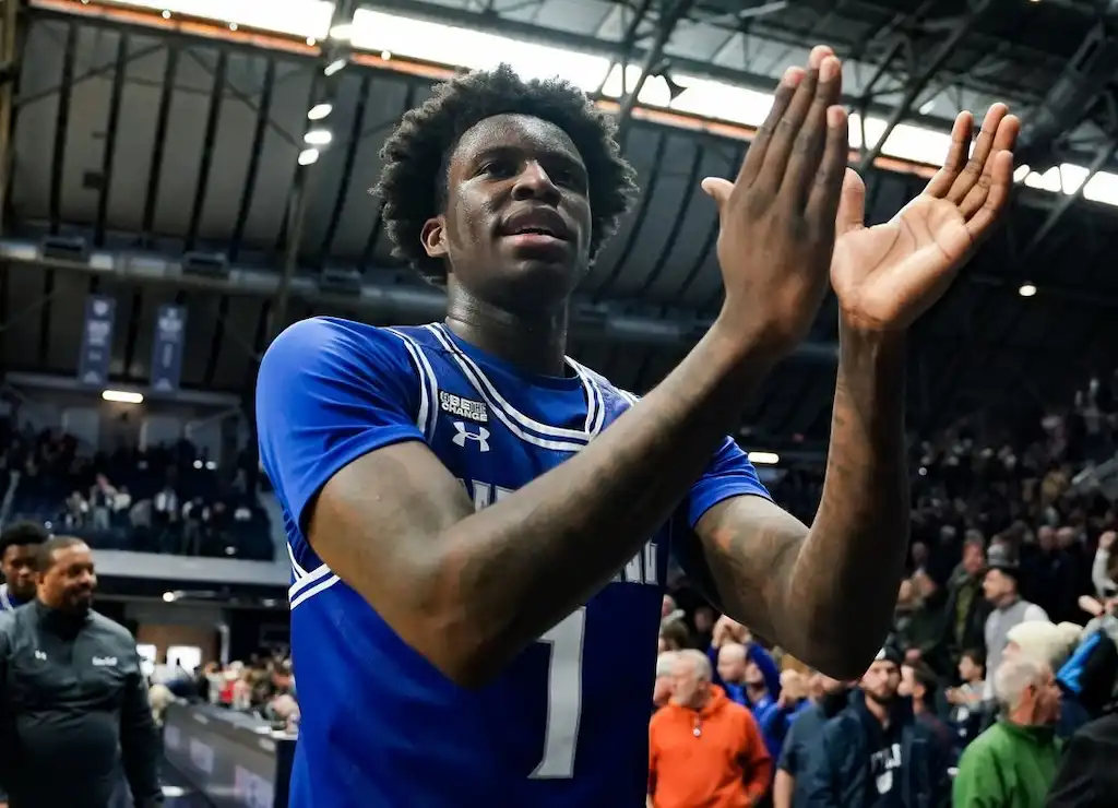 A Seton Hall player applauds while walking off the court.
