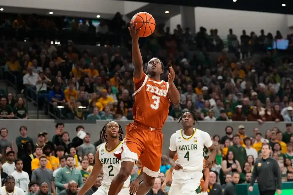 A Texas basketball player goes up for a layup.
