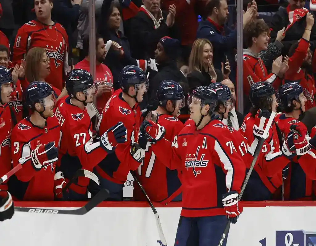 Washington Capitals players line up for high fives at the bench during NHL game against Winnipeg Jets